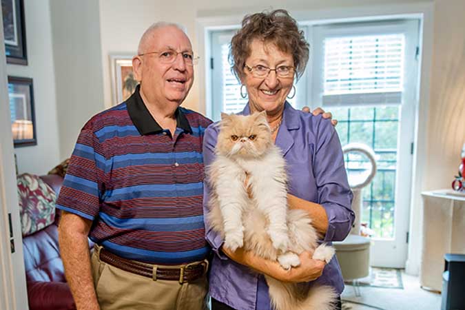 A couple holding their cat at The Estates at Carpenters in Lakeland, Florida.