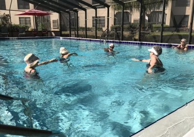 Estates at Carpenters - group of seniors enjoying water aerobics in an outdoor pool