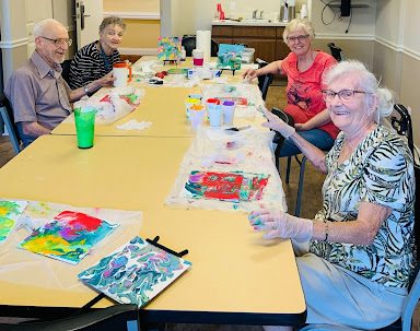 estates at carpenters residents in a painting class