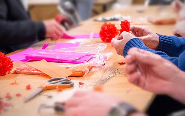 close up of seniors working on a paper craft